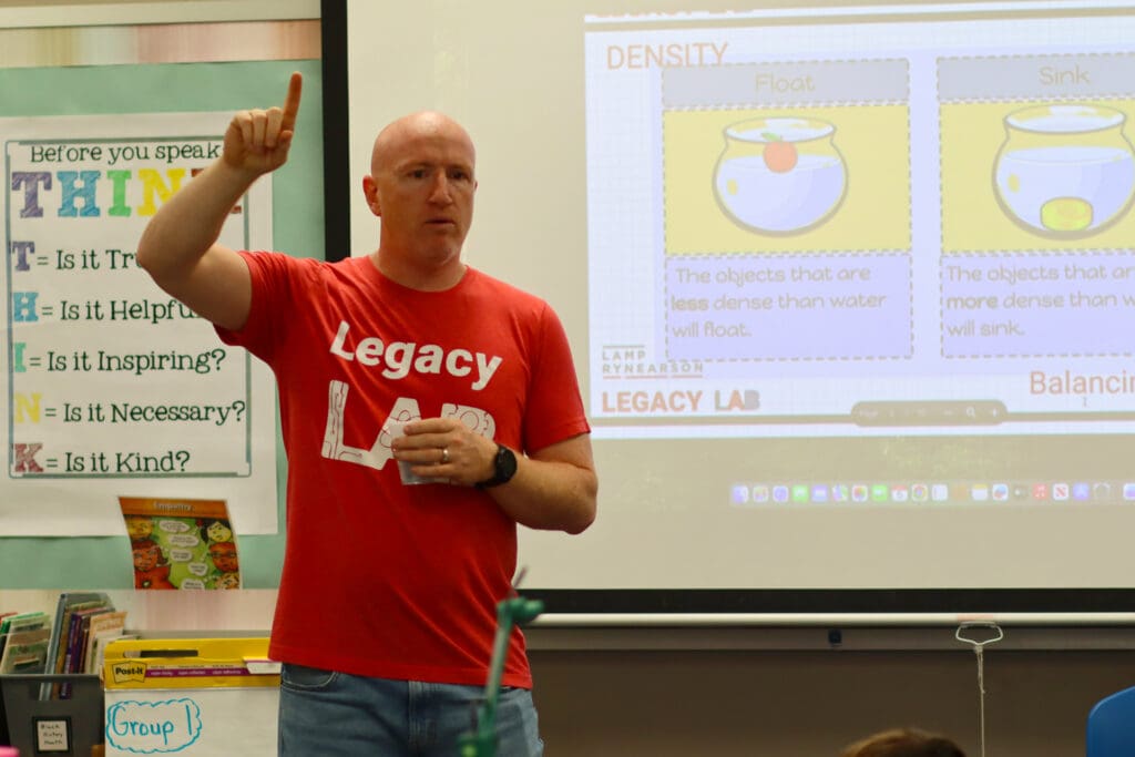 Legacy LAB founding member and civil engineer Tyler Klusaw speaking to a classroom