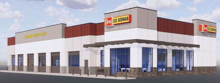 Exterior view of a single-story tire shop with multiple garage bays and a prominent 'Tires Les Schwab' sign on the roofline.