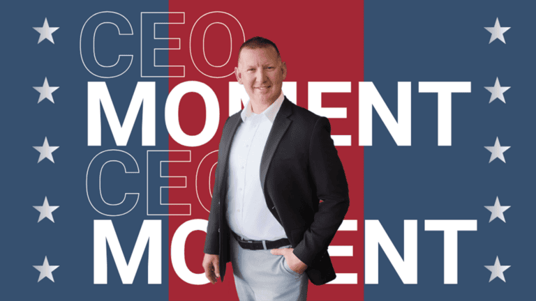 Smiling man in a suit standing in front of a red-and-blue patriotic background with the words ‘CEO MOMENT’ repeated.